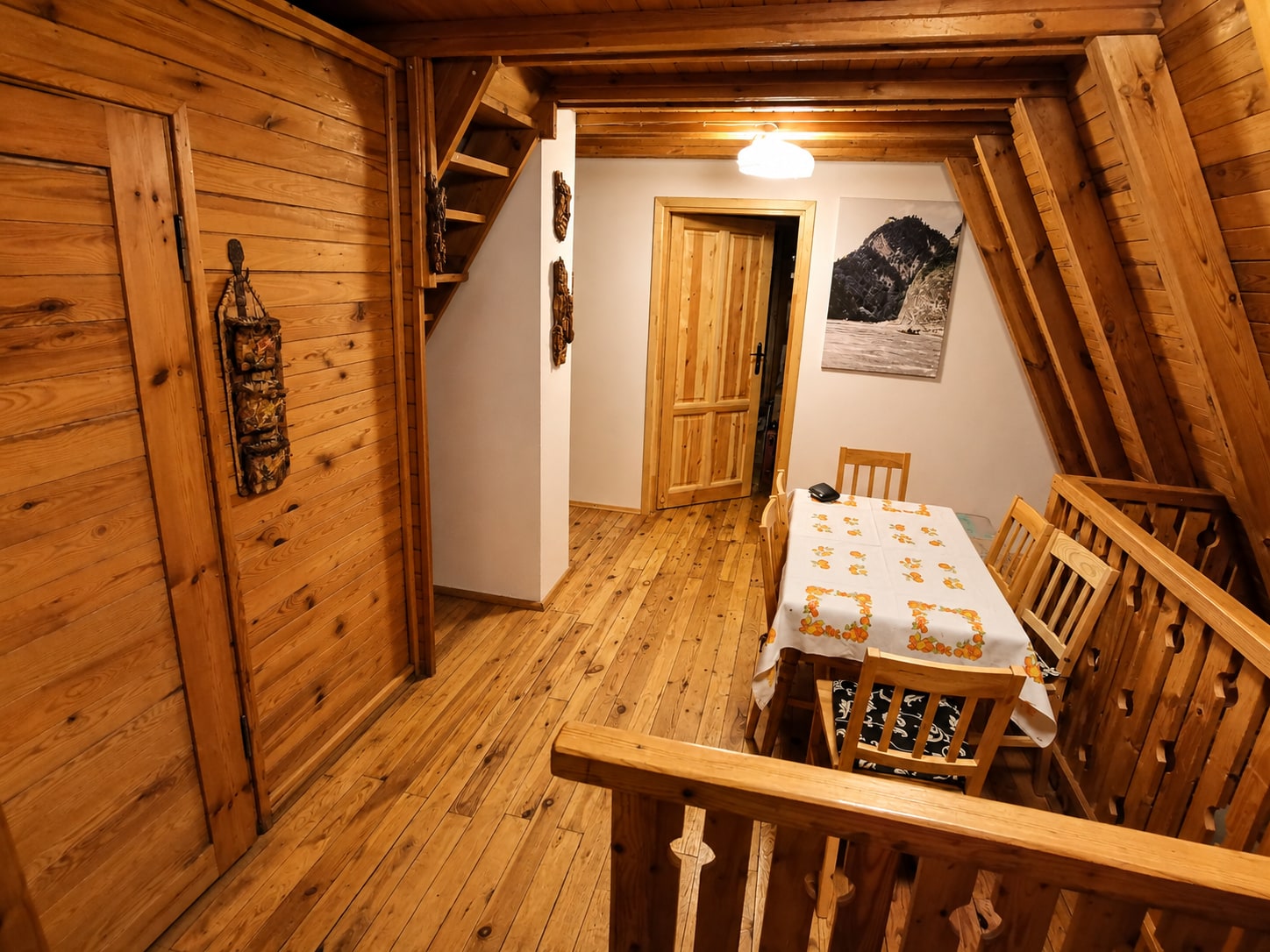 Timber-lined shared space on the first floor with a dining table
