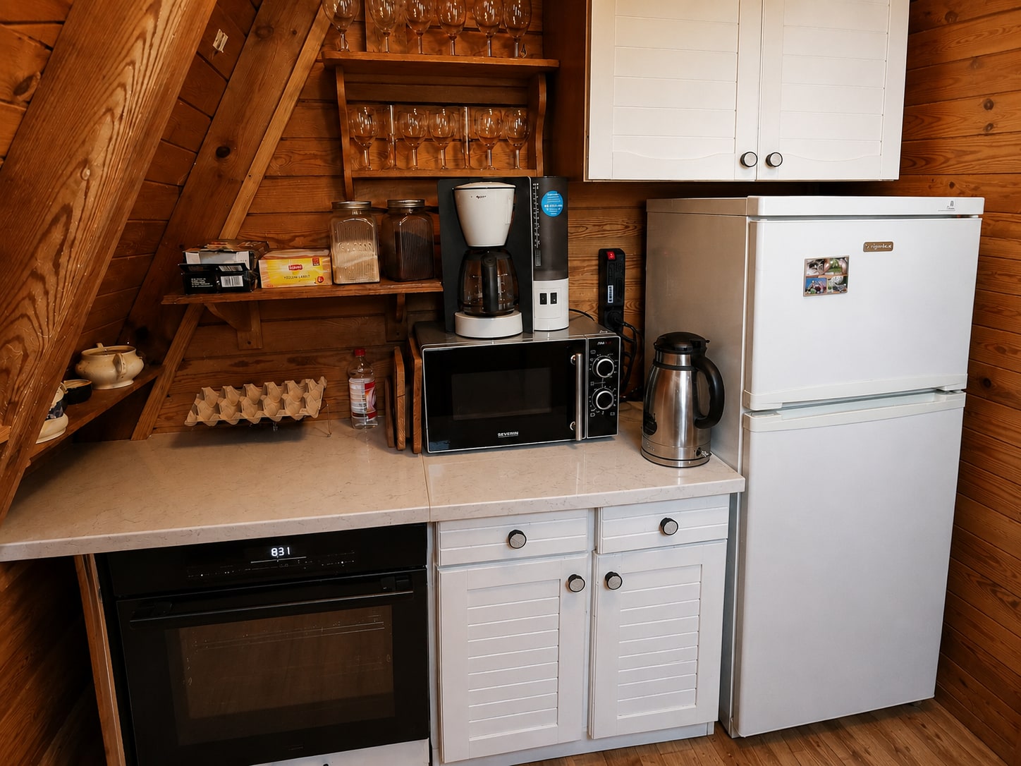 Equipped kitchen with a refrigerator and coffee machine